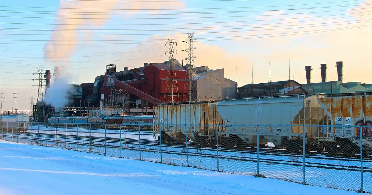 A steel plant with smokestacks and rail cars beside snow on the Cuyahoga River in Cleveland