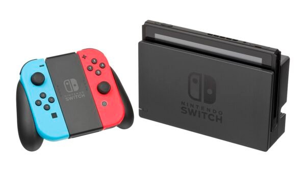 Nintendo Switch console in its dock next to red and blue Joy-Con controllers in a grip
